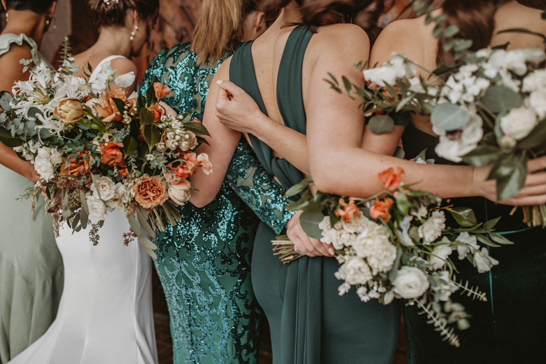 Bridesmaids in matching dresses holding bouquets