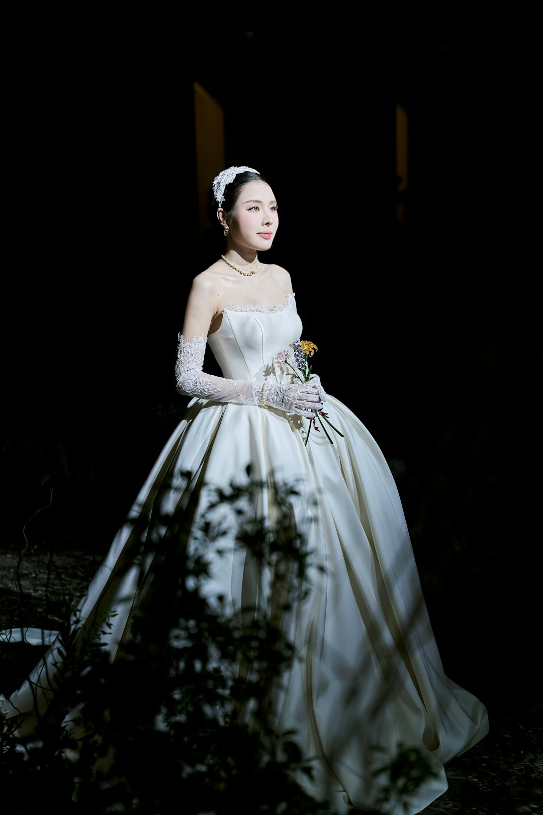 Elegant bride in a white gown holding a bouquet