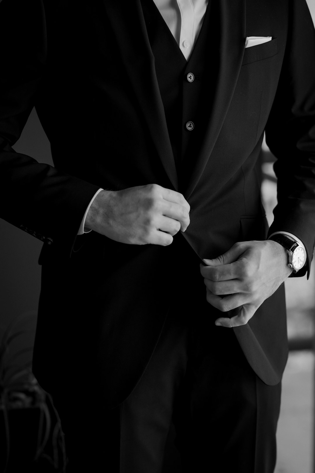 Man adjusting his formal suit jacket