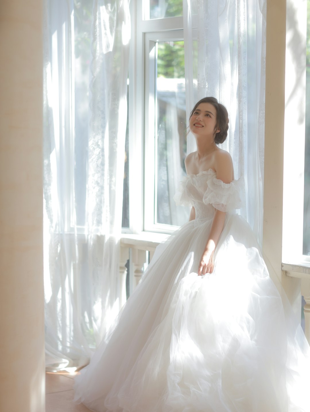 Marchetti Bridal bride at a window